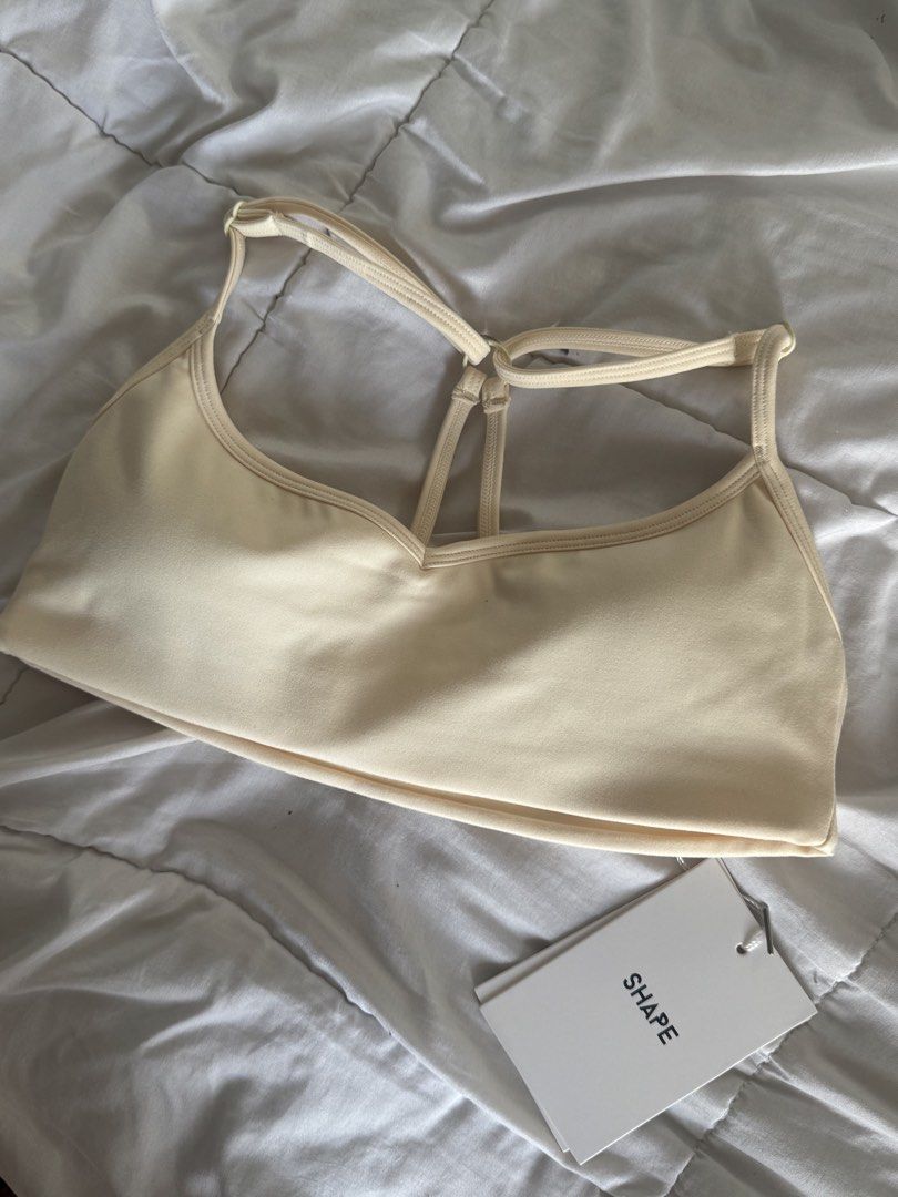 BNWT SHAPE Active Tone Sports Bra Cream Size S (Category: Activewear) located in Pasig City. Submitted by vanillaice__ (Listing ID 1469929091, Image 2). Description: - Brand New with tags - Color: Cream yellow - Condition: Brand new with tags (never worn) - Design: Scoop neckline with a stylish multi-strap back - Material: Soft and comfortable stretch fabric.