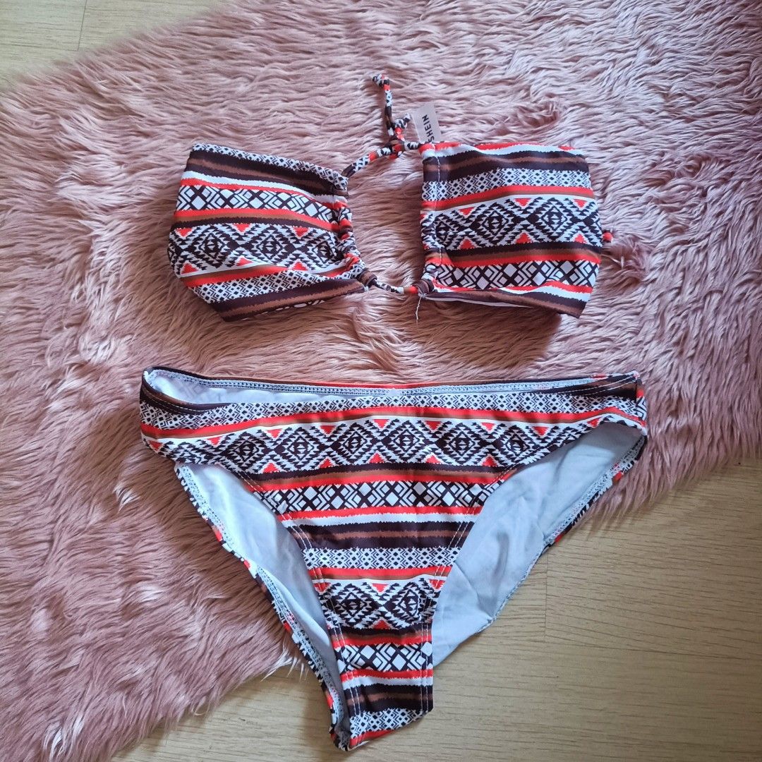 Shein Aztec Print Two-Piece Bikini Swimsuit (Category: Bikinis & Swimsuits) located in Bacoor. Submitted by Miss_Chuch0521 (Listing ID 1469808714, Image 1). Description: - Brand: Shein - Condition: Brand new with tag attached to the top, never worn out - Style: Two-piece bikini set - Design: Geometric Aztec print with red, white, brown, and black horizontal stripes - Top: Strapless bandeau with a center halter neck tie string - Bottoms: Matching 