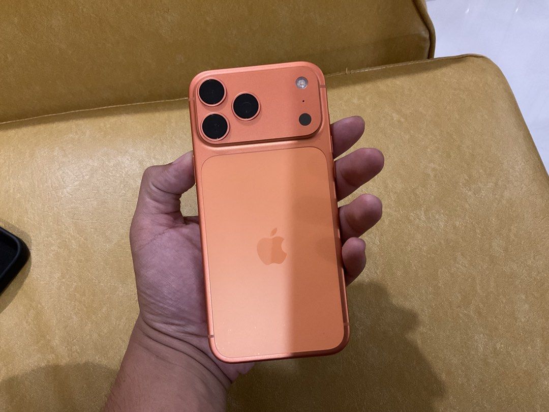 Smartphone Apple iPhone 17 Pro Max Orange (Category: Others) located in Manila. Submitted by aarondanie17006 (Listing ID 1469871621, Image 3). Description: - Model: Apple iPhone 17 Pro Max 256 GB - Color: Matte Orange - Camera: Advanced triple-camera setup with a rounded module - Body: Premium aluminum finish - Controls: Standard physical buttons, volume controls, and power key - Condition: Clean black front screen, ready for a new owner - RFS: U