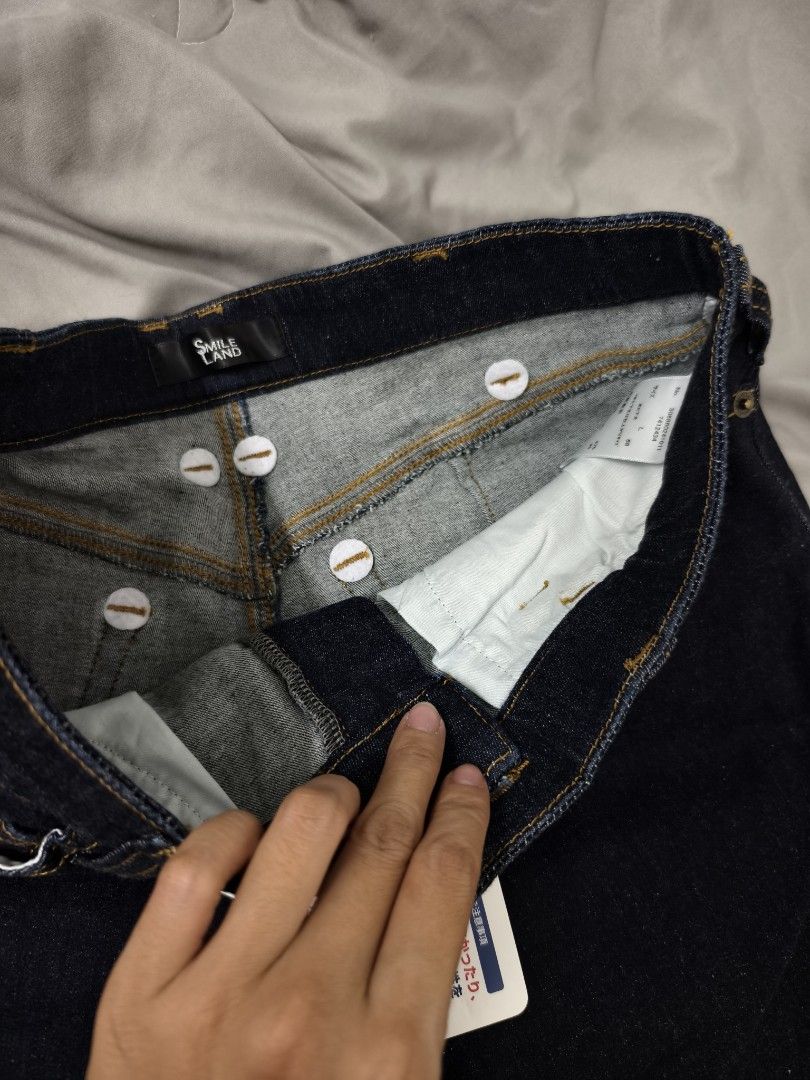 Smile Land Dark Denim Jeans Size L (Category: Jeans) located in Angeles City. Submitted by measaliman02351 (Listing ID 1469858263, Image 3). Description: - Brand: Smile Land - Size: L - Condition: Brand new with original store tags attached - Wash: Classic dark wash with contrast stitching - Fit: Straight leg cut - Details: Trendy multiple button closures at the waistband - Style: Versatile everyday staple piece.