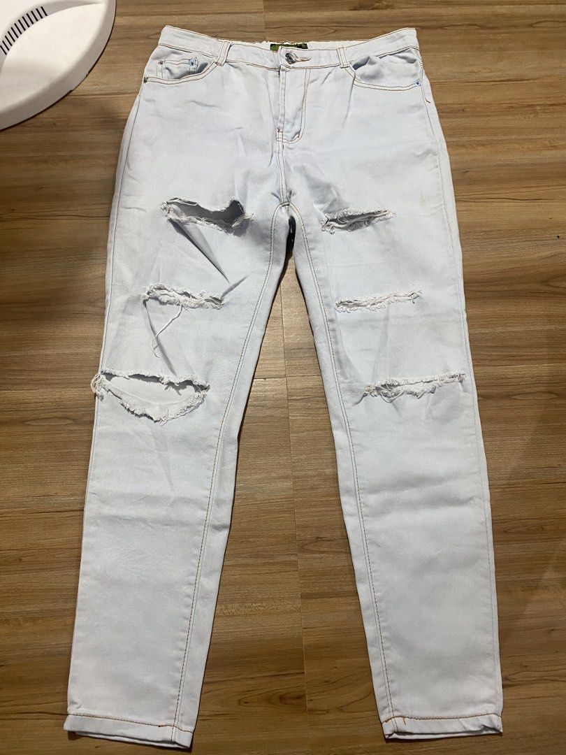 Soft denim 32"-34" length 36.5" (Category: Jeans) located in Bulacan. Submitted by Spothings (Listing ID 1469866961, Image 1). Description: - Color: Light wash blue - Fit: Straight leg - Design: Distressed rips on front, thighs, and back pockets - Details: Classic 5-pocket style with brown contrast stitching - Closure: Front button and zipper.