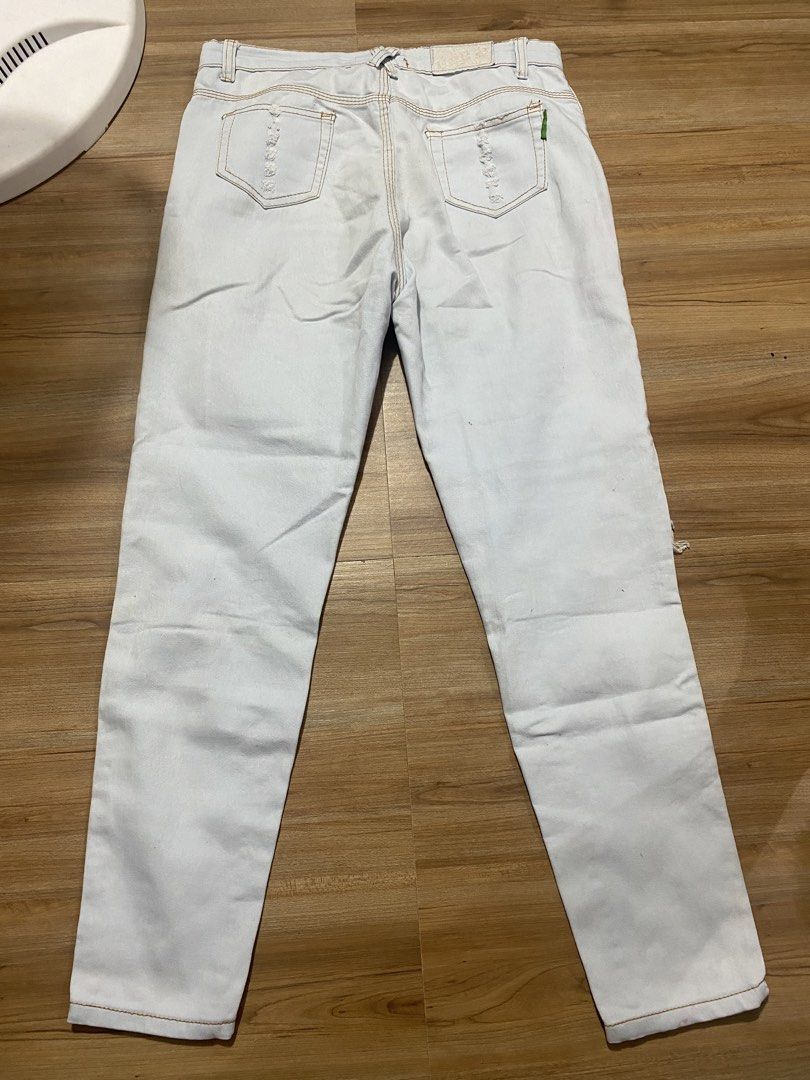 Soft denim 32"-34" length 36.5" (Category: Jeans) located in Bulacan. Submitted by Spothings (Listing ID 1469866961, Image 2). Description: - Color: Light wash blue - Fit: Straight leg - Design: Distressed rips on front, thighs, and back pockets - Details: Classic 5-pocket style with brown contrast stitching - Closure: Front button and zipper.