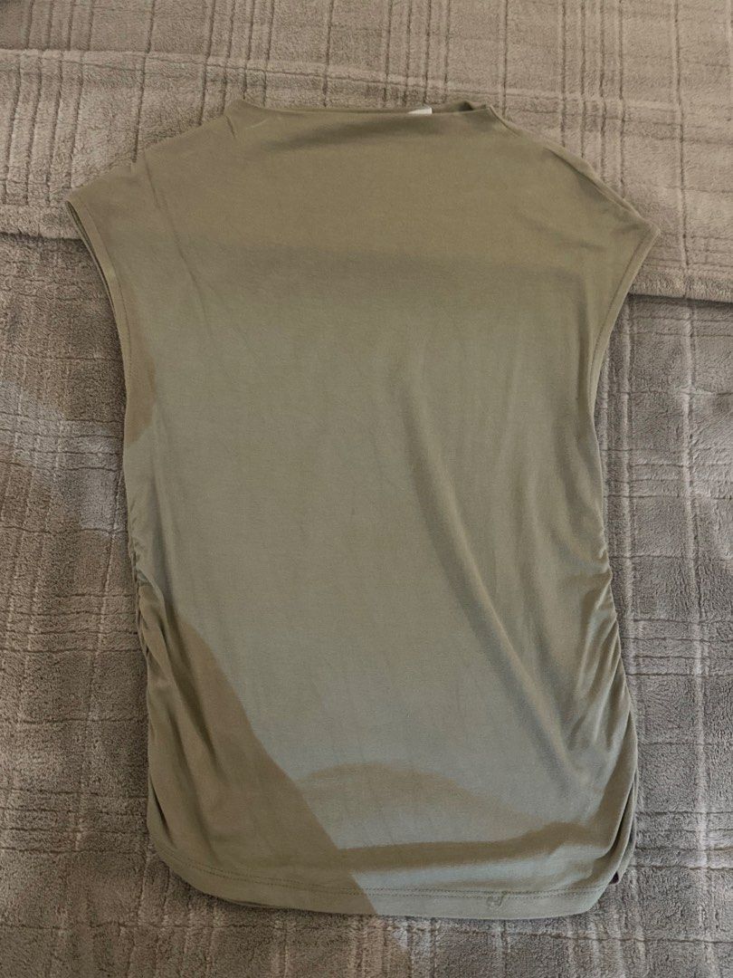 Stradivarius khaki sleeveless top size S (Category: Sleeveless) located in Manila. Submitted by cabuniagpr58494 (Listing ID 1469872925, Image 1). Description: - Brand: Stradivarius - Color: Khaki green - Size: Small (Regular fit) - Design: Boat neckline with trendy gathered sides - Material: Soft and stretchy jersey - Versatility: Great basic piece for pairing with jeans or skirts.