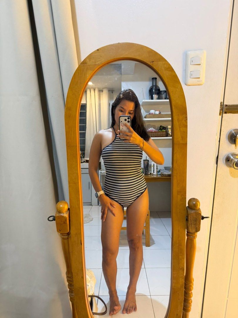 Striped Halter One-Piece Swimsuit (Category: Bikinis & Swimsuits) located in Mandaluyong City. Submitted by chocofudge__ (Listing ID 1469784566, Image 1). Description: - Navy blue and white horizontal striped one-piece swimsuit - Chic halter neckline with open shoulders and back - Stretchy fabric for a comfortable fit - Provides moderate coverage - Perfect for beach trips, pool lounging, and tropical getaways - Clean and ready to wear.