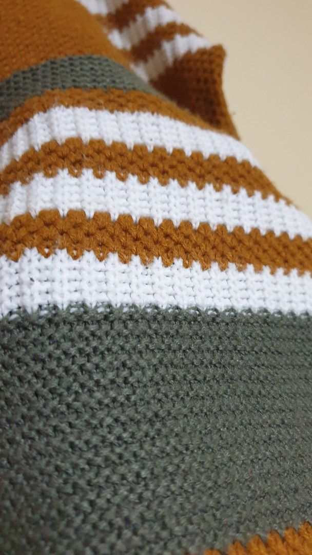 Striped Knit Sweater Brown White Green (Category: Longsleeves) located in Pasig City. Submitted by Eternity_Care (Listing ID 1469859307, Image 2). Description: - Cozy knit sweater in brown, white, and dark green stripes - Features a trendy criss-cross strap detail around the neckline - Long sleeves with comfortable ribbed cuffs - Soft, warm material perfect for cooler weather -Large to XL -Negotiable price.