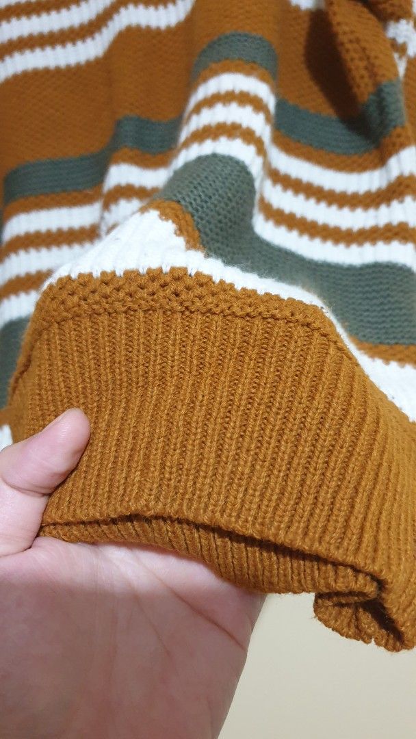 Striped Knit Sweater Brown White Green (Category: Longsleeves) located in Pasig City. Submitted by Eternity_Care (Listing ID 1469859307, Image 3). Description: - Cozy knit sweater in brown, white, and dark green stripes - Features a trendy criss-cross strap detail around the neckline - Long sleeves with comfortable ribbed cuffs - Soft, warm material perfect for cooler weather -Large to XL -Negotiable price.
