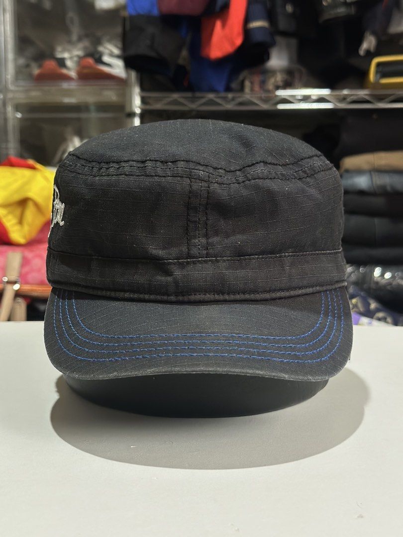Stüssy Increasing the Peace Black Cadet Hat (Category: Caps & Hats) located in Daet. Submitted by thrifthings2018 (Listing ID 1469847808, Image 3). Description: - Brand: Stüssy - Style: Cadet hat / Military cap - Material: 100% cotton with inner logo lining - Color: Black with blue contrast stitching along the brim - Details: White side embroidery ('Increasing the Peace Since 1980') and 30th anniversary back graphic - Fit: Adjustable strap closur