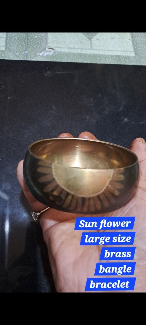 Sun flower large size brass bangle bracelet (Category: Bracelets) located in Davao. Submitted by bravemoon_556cd5 (Listing ID 1469875728, Image 1). Description: - Chunky cuff style with a solid, high-quality weight - Beautiful etched sunflower design in polished brass - Contrasting darkened background finish - Slips on easily for effortless wear - Statement piece that stands out.