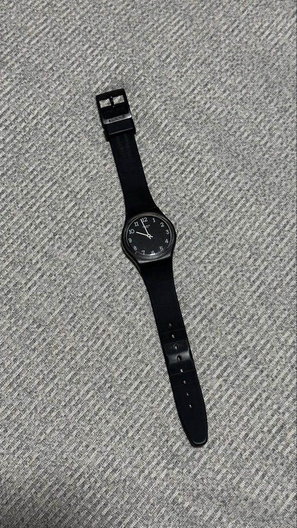 Swatch Black Analog Wristwatch (Category: Women's Watches) located in Bantay. Submitted by e.loi.sa (Listing ID 1469783113, Image 3). Description: - Authentic Swiss-made black Swatch wristwatch - Minimalist black dial with easy-to-read white Arabic numerals and hands - Comfortable and durable black silicone strap with buckle closure - Lightweight design ideal for daily wear - Versatile style that matches any outfit.