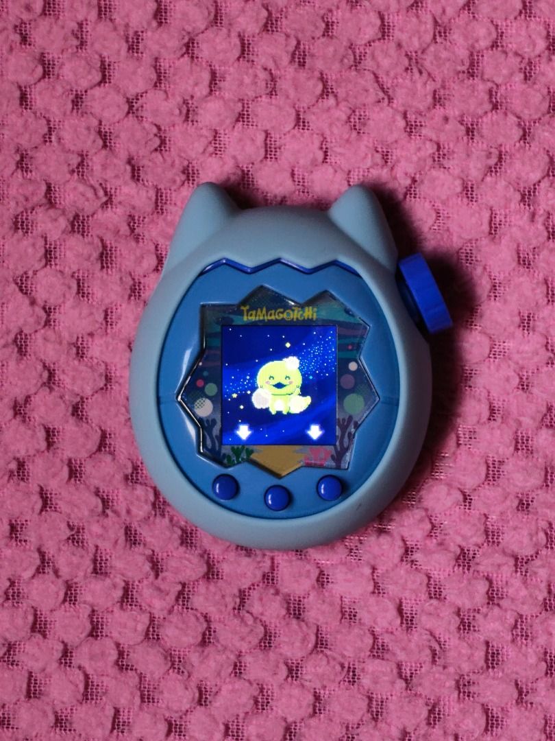 Tamagotchi Paradise with Custom Silicone Case (Category: Interactive Toys) located in Pasay City. Submitted by marlontobias (Listing ID 1469831771, Image 1). Description: - Authentic Tamagotchi Paradise virtual pet in blue - Includes adorable custom blue cat silicone cover with controller graphic and dial - Fully functional with an active color screen - Healthy virtual character currently being raised - Batteries already included, ready to play u