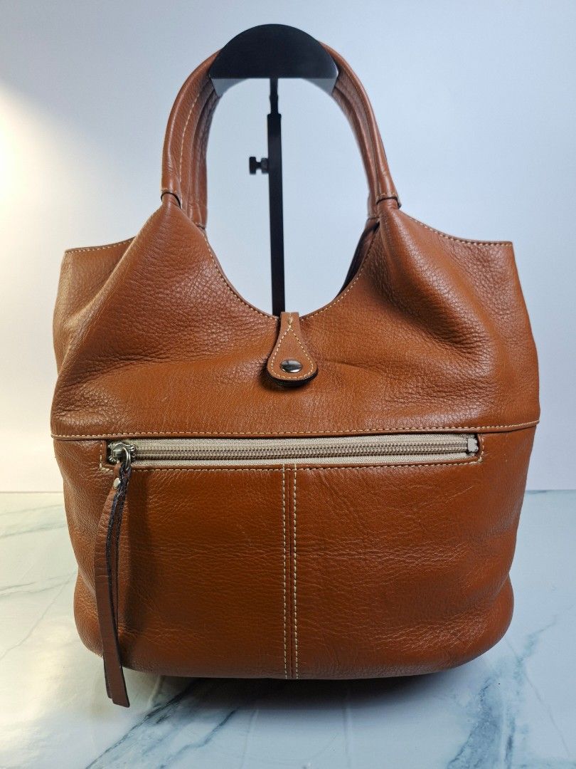 Tan Brown Leather Bag with Front Pocket and Zips (Category: Shoulder Bags) located in Pasay City. Submitted by onick_79 (Listing ID 1469926989, Image 2). Description: -Dimensions: L 28 x H 25 x W 18cm - Material: Tan pebbled leather with contrasting white topstitching - Handles: Structured dual top handles for easy carrying - Pockets: Front flap pocket with magnetic snap closure - Accents: Stylish vertical zipper details on the front and back ext