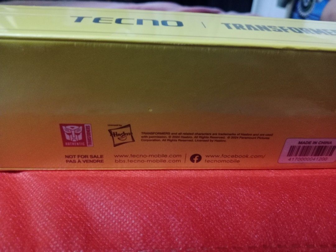 Tecno Transformers Bumblebee T05 Bluetooth Earbuds (Category: Earphones) located in Manila. Submitted by hapondevera_41 (Listing ID 1469898695, Image 2). Description: Official Tecno and Transformers collaboration wireless earbuds. Bumblebee yellow themed packaging featuring the Autobot logo. Model T05 Bluetooth earphones inside. Licensed by Hasbro and Paramount Pictures. Rare collectible audio gear for fans. Unused item in original sealed box..