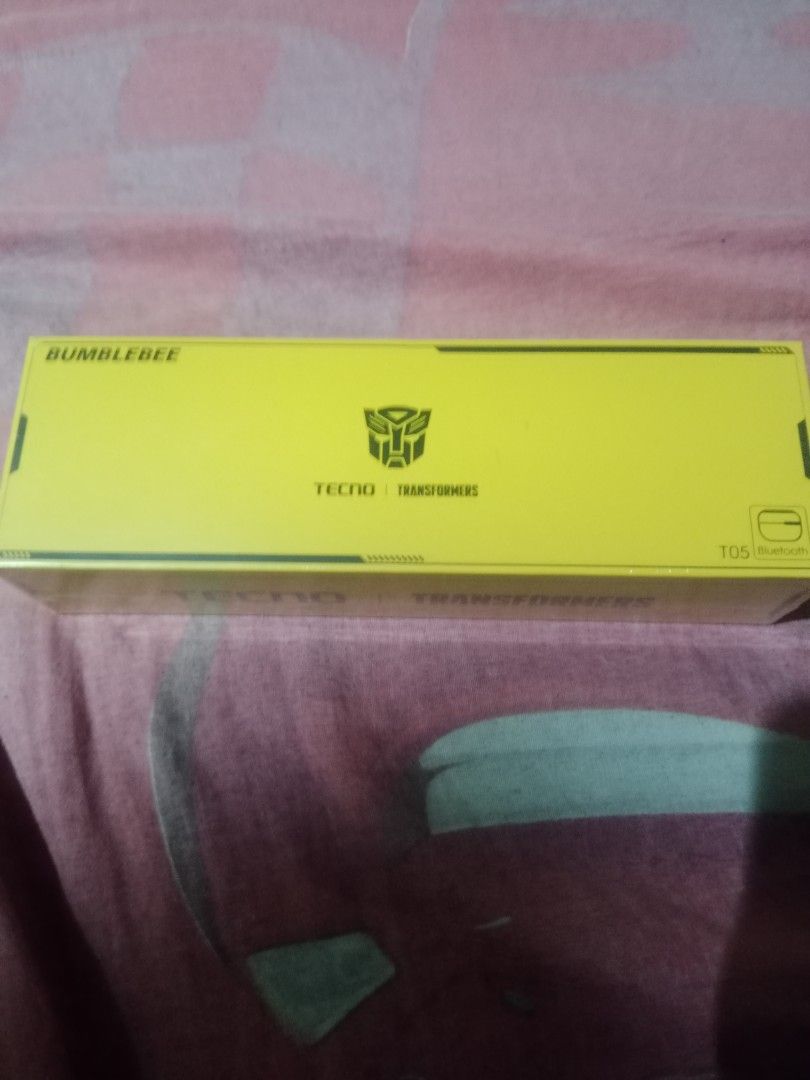 Tecno Transformers Bumblebee T05 Bluetooth Earbuds (Category: Earphones) located in Manila. Submitted by hapondevera_41 (Listing ID 1469898695, Image 3). Description: Official Tecno and Transformers collaboration wireless earbuds. Bumblebee yellow themed packaging featuring the Autobot logo. Model T05 Bluetooth earphones inside. Licensed by Hasbro and Paramount Pictures. Rare collectible audio gear for fans. Unused item in original sealed box..
