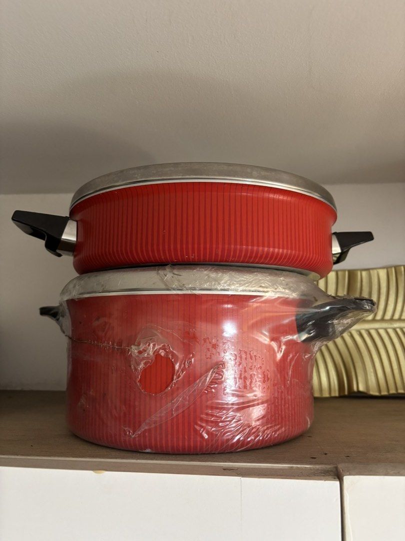 Tefal Red Non-Stick Cookware Pots with Lids (Category: Cookware & Accessories) located in Paranaque City. Submitted by craftywoobieph (Listing ID 1469863391, Image 1). Description: - Brand new, unused red ribbed cookware pots - Includes 2 stacked pots with stainless steel lids - Features sturdy black side handles - Bottom pot is still wrapped in clear protective plastic (with minor tears in the film) - Great addition to your kitchen setup - Ships