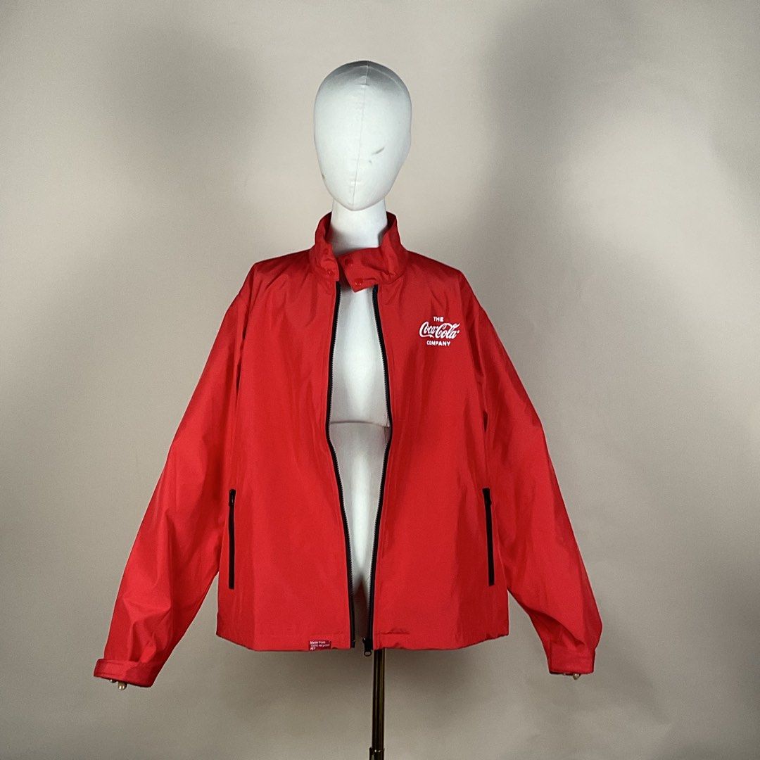 The Coca Cola Company Red Windbreaker Jacket (Category: Coats, Jackets and Outerwear) located in La Trinidad. Submitted by di_tiyak (Listing ID 1469778366, Image 3). Description: - Authentic The Coca-Cola Company zip-up jacket in bright red - Eco-friendly build made from 100% recycled PET - White Coca-Cola logo printed on the chest - Bold 'Refresh the World. Make a Difference.' slogan on the back - Practical storage with two front zippered hand p