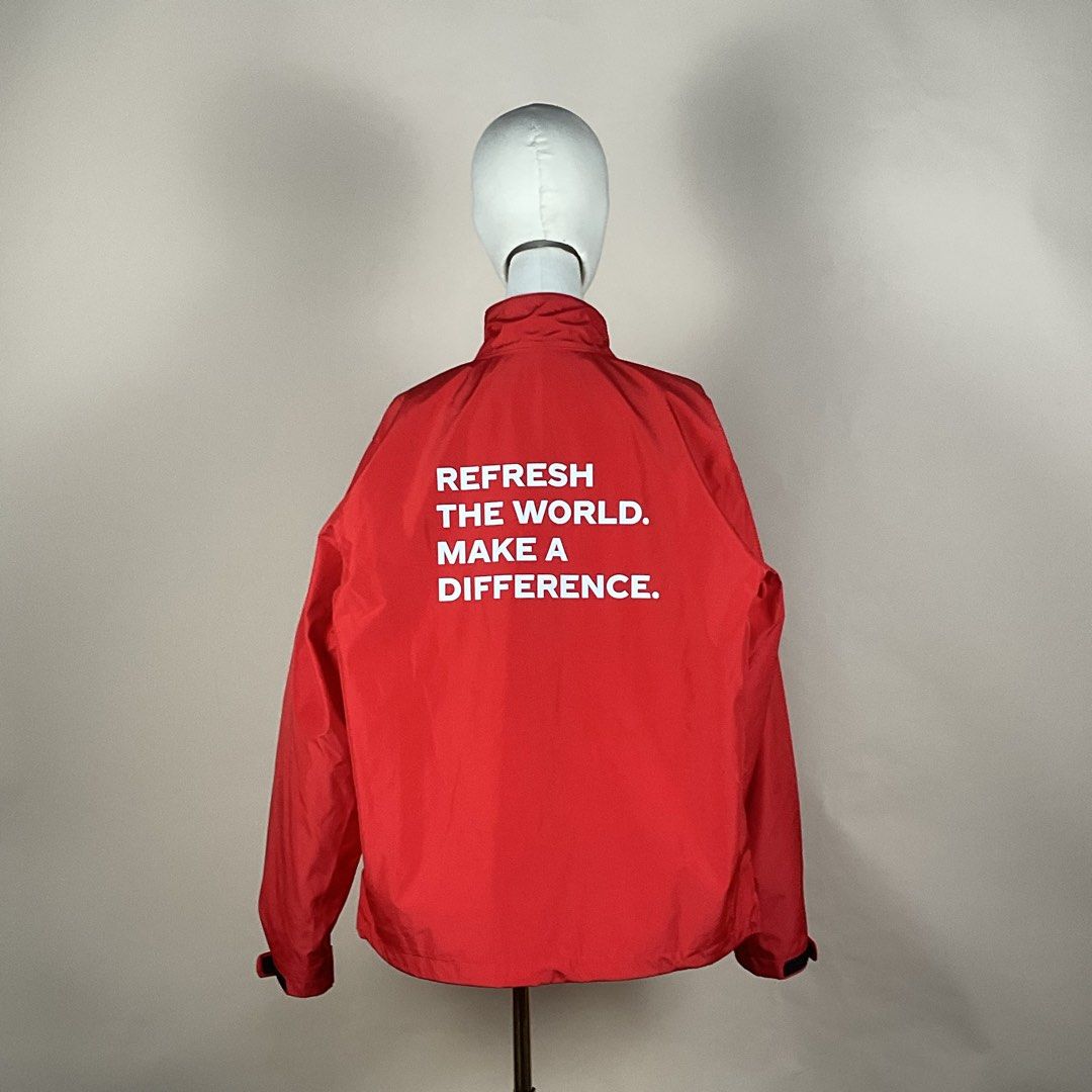 The Coca Cola Company Red Windbreaker Jacket (Category: Coats, Jackets and Outerwear) located in La Trinidad. Submitted by di_tiyak (Listing ID 1469778366, Image 2). Description: - Authentic The Coca-Cola Company zip-up jacket in bright red - Eco-friendly build made from 100% recycled PET - White Coca-Cola logo printed on the chest - Bold 'Refresh the World. Make a Difference.' slogan on the back - Practical storage with two front zippered hand p