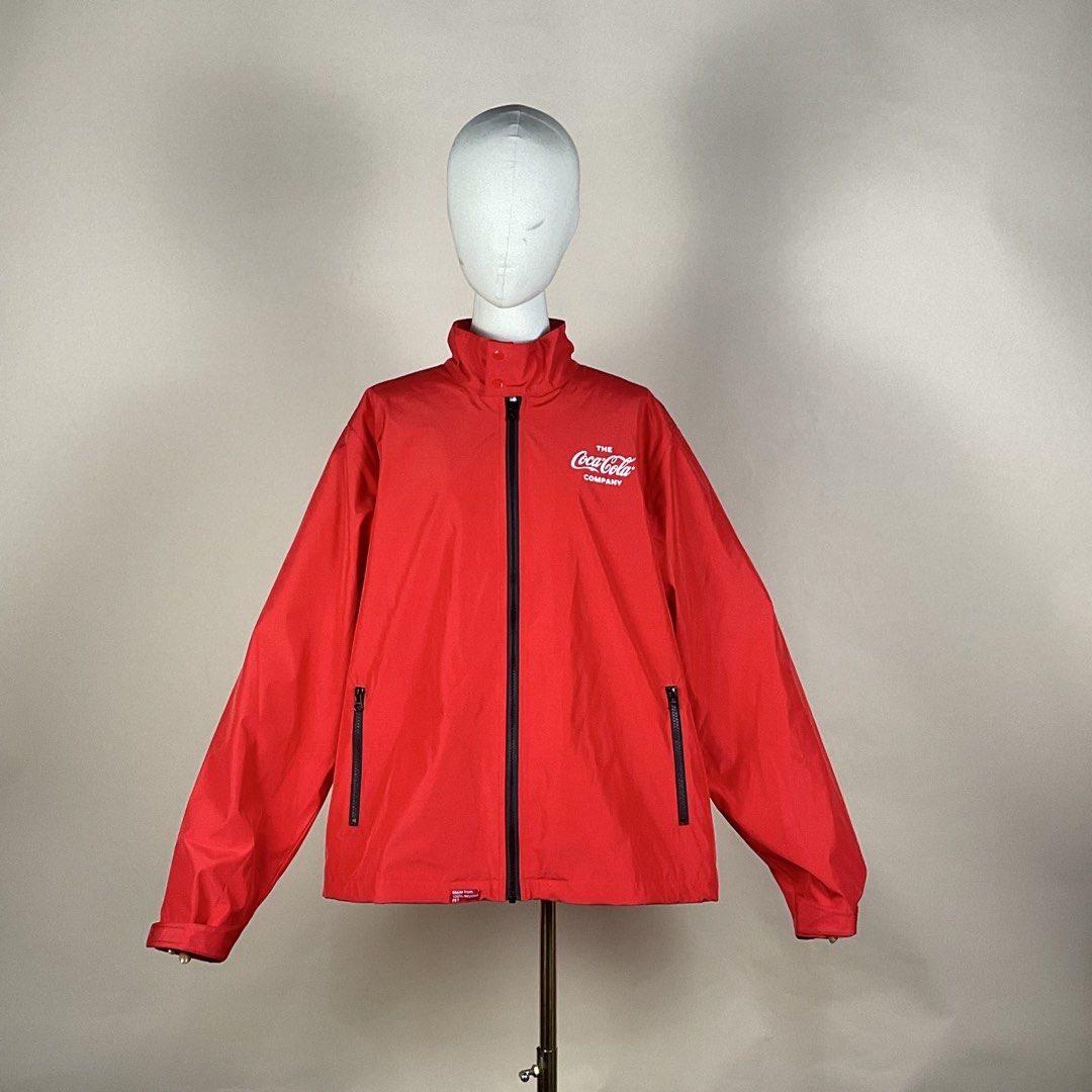 The Coca Cola Company Red Windbreaker Jacket (Category: Coats, Jackets and Outerwear) located in La Trinidad. Submitted by di_tiyak (Listing ID 1469778366, Image 1). Description: - Authentic The Coca-Cola Company zip-up jacket in bright red - Eco-friendly build made from 100% recycled PET - White Coca-Cola logo printed on the chest - Bold 'Refresh the World. Make a Difference.' slogan on the back - Practical storage with two front zippered hand p