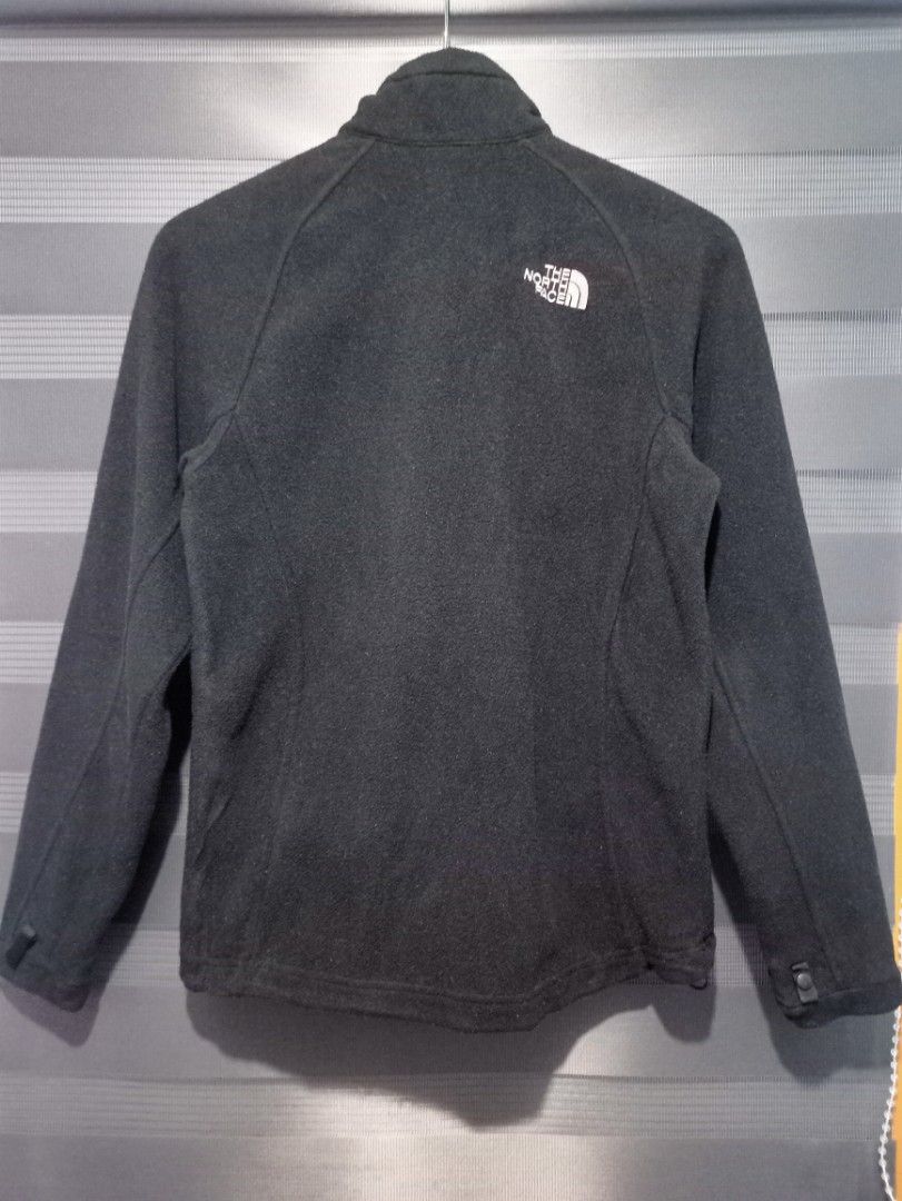The North Face Black Fleece Jacket (Category: Coats, Jackets and Outerwear) located in Manila. Submitted by thecomftrift.co (Listing ID 1469922598, Image 2). Description: - Brand: The North Face - Color: Classic Black with White Embroidered Logo (Chest & Back) - Size: Medium (Regular Fit) - Material: Ultra-soft fleece fabric inside and out - Features: Full-zip front, stand-up collar, 2 zippered hand pockets - Adjustability: Drawcord hem and adjus