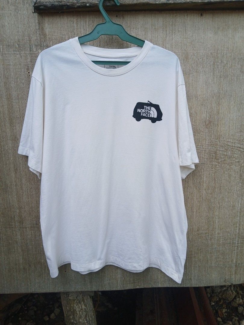 The North Face Never Stop Exploring Van Graphic T-Shirt (Category: Tshirts & Polo Shirts ) located in Moalboal. Submitted by thrift_sixty (Listing ID 1469763799, Image 1). Description: - Brand: The North Face - Color: Crisp White - Size: XL US / XXL Asia - Material: 100% Cotton (Relaxed fit, very comfortable) - Design: Small chest logo on front, large retro yellow camper van with 'Never Stop Exploring' banner on the back - Condition: Clean fabric