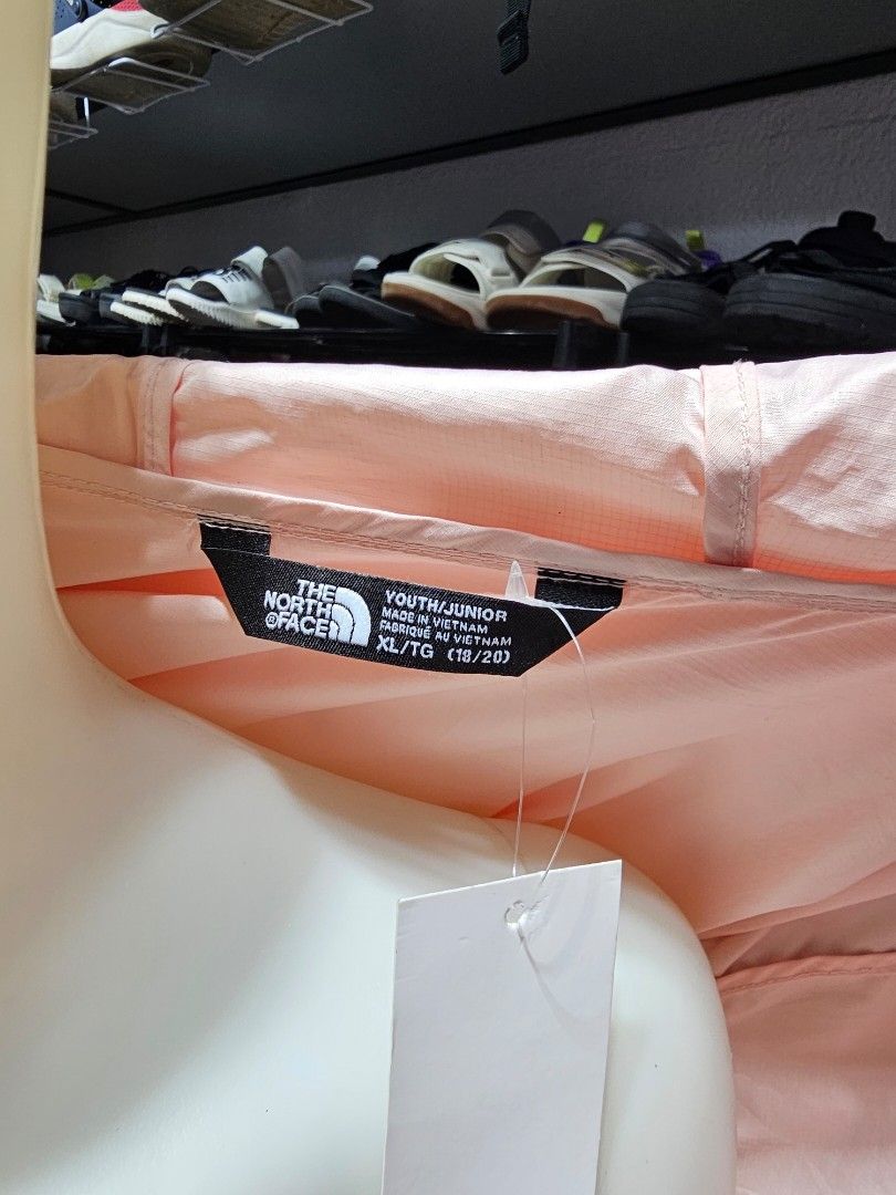 The North Face windbreaker jumper (Category: Coats, Jackets and Outerwear) located in Baguio. Submitted by kayeonlineshop (Listing ID 1469846539, Image 3). Description: light pink The North Face hooded windbreaker jacket featuring a full-zip front and a bold brand logo down the sleeve,.