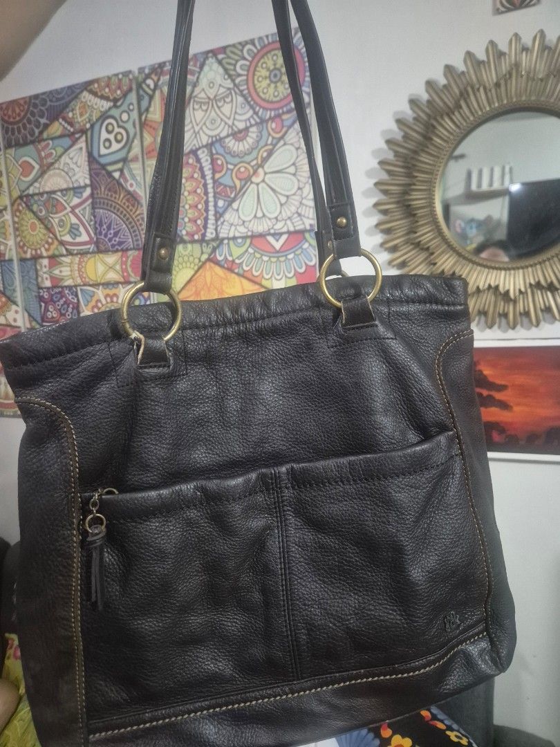 The sak.leather bag (Category: Shoulder Bags) located in Las Pinas. Submitted by bohotrove (Listing ID 1469906490, Image 1). Description: - Color: Dark brown - Material: Soft textured leather - Hardware: Brass-tone rings and accents - Storage: Roomy main compartment, front vertical slip pocket, and zippered pocket with leather pull - Straps: Twin shoulder straps - Details: Contrast topstitching throughout.