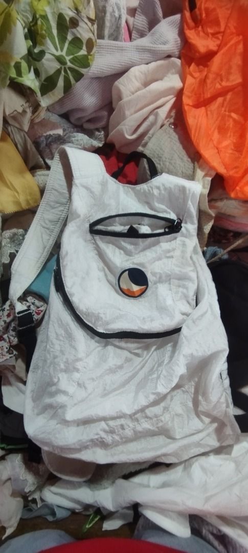 Ticket to the Moon Mini Backpack White (Category: Backpacks) located in Koronadal. Submitted by jrdar (Listing ID 1469796697, Image 1). Description: - Brand/Model: Ticket to the Moon Mini Backpack - Color: White - Material: Lightweight parachute fabric - Features: Front zippered pocket with logo patch, adjustable straps, and top handle - Convenience: Folds down compactly for easy storage - Best For: Quick trips, daily use, and travel.