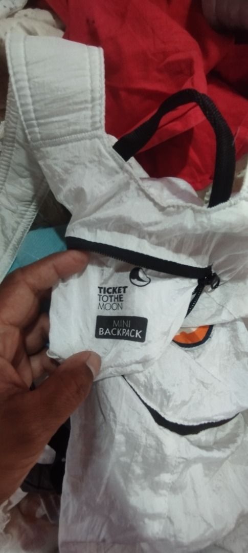 Ticket to the Moon Mini Backpack White (Category: Backpacks) located in Koronadal. Submitted by jrdar (Listing ID 1469796697, Image 2). Description: - Brand/Model: Ticket to the Moon Mini Backpack - Color: White - Material: Lightweight parachute fabric - Features: Front zippered pocket with logo patch, adjustable straps, and top handle - Convenience: Folds down compactly for easy storage - Best For: Quick trips, daily use, and travel.