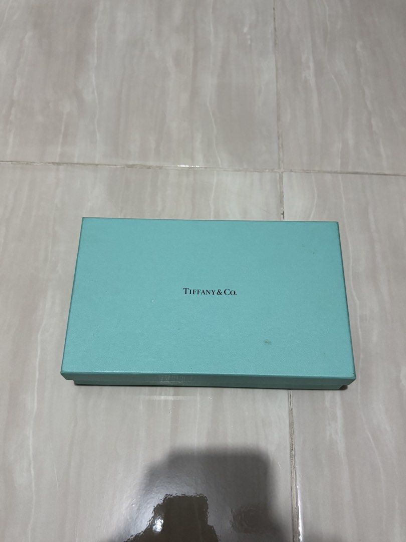 TIFFANY & CO LEATHER SILVER TONE LONG WALLET (Category: Luxury Bags & Wallets) located in Naga. Submitted by sislovesme (Listing ID 1469877194, Image 1). Description: •IN VERY GOOD CONDITION •WITH BOX •NEED CLEANING SINCE STOCK PO SYA •AUTHENTIC.