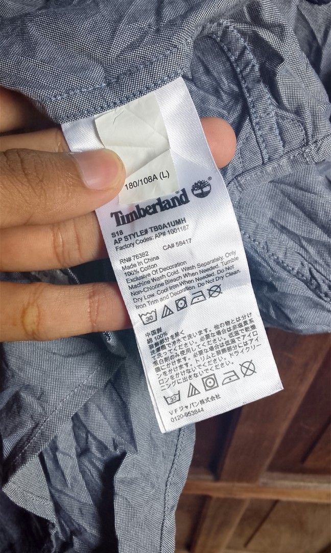 TIMBERLAND (Category: Tshirts & Polo Shirts ) located in Manila. Submitted by plong7 (Listing ID 1469761403, Image 3). Description: DIMES: 21x29 Brand: Timberland Style: Short-sleeve button-down casual shirt Color: Slate gray / chambray blue-gray Fabric: Lightweight cotton — breathable & comfortable Details: Classic collar, clean white buttons, small embroidered Timberland tree logo on left chest Fit: Regular fit — great for everyday casual or sm