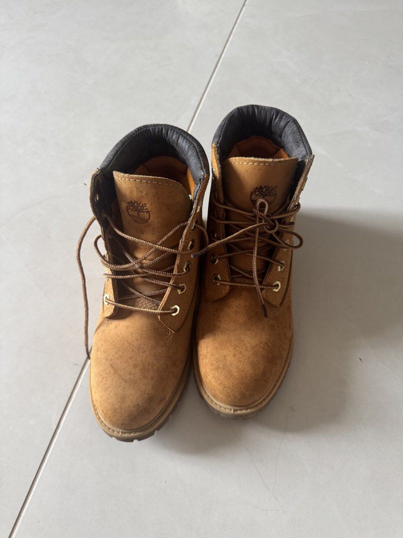 Timberland Classic Wheat Waterproof Boots (Category: Boots) located in Quezon City. Submitted by tinylee60 (Listing ID 1469767791, Image 1). Description: - Brand: Timberland - Material: Classic wheat nubuck leather upper with dark brown padded leather collar - Details: Brown woven laces, metal eyelets, and signature tree logo stamped on durable rubber lug soles - Condition: Shows natural wear and water spots consistent with regular use; sturdy co