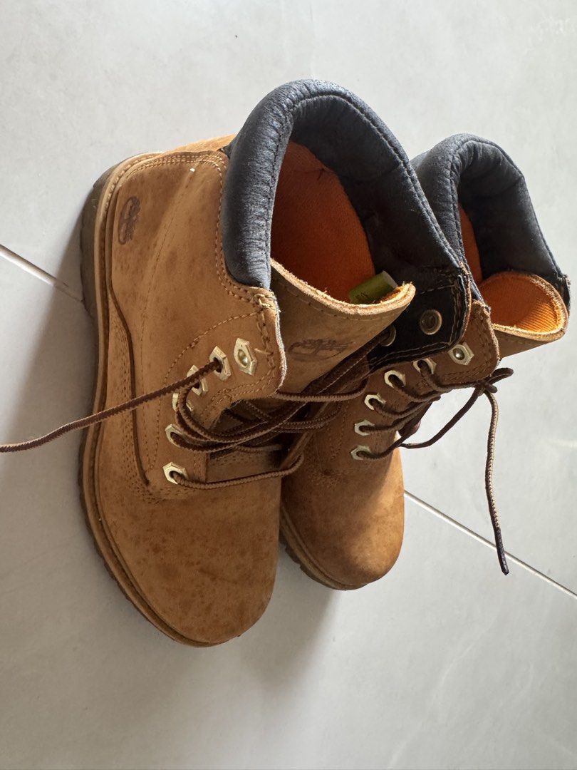 Timberland Classic Wheat Waterproof Boots (Category: Boots) located in Quezon City. Submitted by tinylee60 (Listing ID 1469767791, Image 3). Description: - Brand: Timberland - Material: Classic wheat nubuck leather upper with dark brown padded leather collar - Details: Brown woven laces, metal eyelets, and signature tree logo stamped on durable rubber lug soles - Condition: Shows natural wear and water spots consistent with regular use; sturdy co