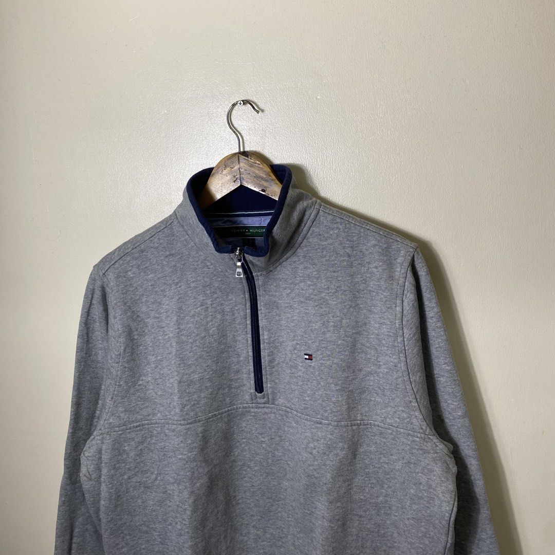 Tommy Hilfiger Golf Grey Quarter Zip Sweatshirt (Category: Coats, Jackets and Outerwear) located in Cebu City. Submitted by theloose.thread (Listing ID 1469835182, Image 2). Description: - Brand: Tommy Hilfiger Golf - Color: Grey with navy blue collar lining and striped detailing - Size: US S / EU M - Material: Comfortable cotton blend - Details: Small embroidered flag logo on the left chest, ribbed cuffs and hem - Condition: Great for layering o