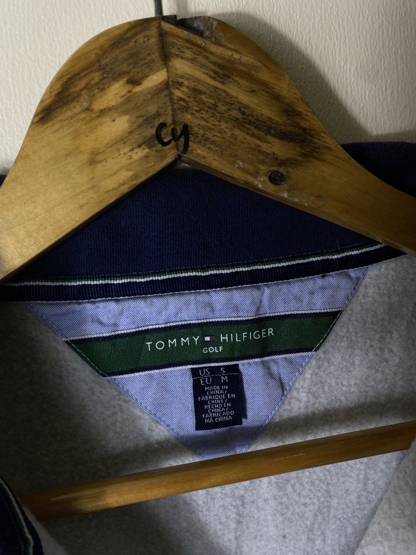 Tommy Hilfiger Golf Grey Quarter Zip Sweatshirt (Category: Coats, Jackets and Outerwear) located in Cebu City. Submitted by theloose.thread (Listing ID 1469835182, Image 3). Description: - Brand: Tommy Hilfiger Golf - Color: Grey with navy blue collar lining and striped detailing - Size: US S / EU M - Material: Comfortable cotton blend - Details: Small embroidered flag logo on the left chest, ribbed cuffs and hem - Condition: Great for layering o