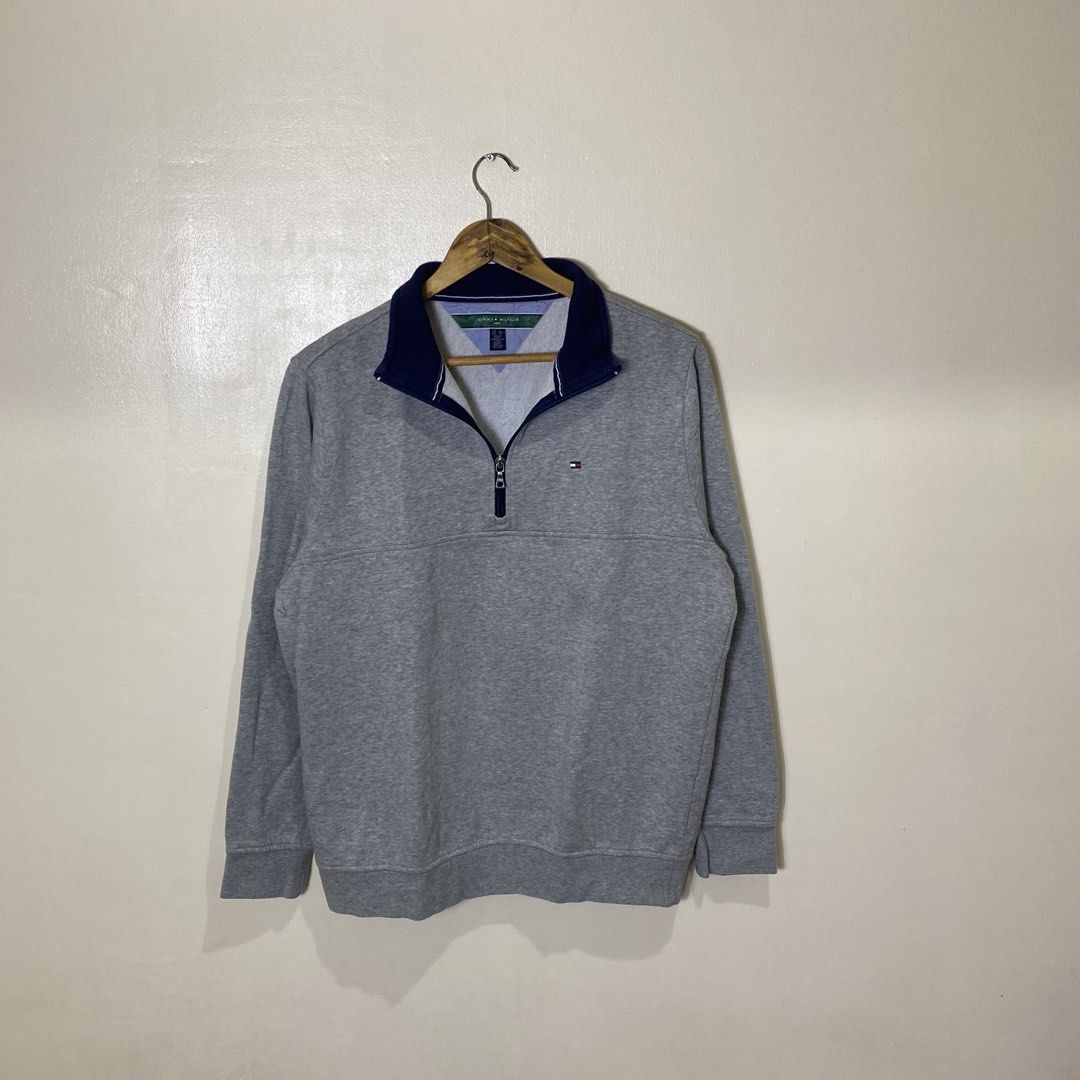 Tommy Hilfiger Golf Grey Quarter Zip Sweatshirt (Category: Coats, Jackets and Outerwear) located in Cebu City. Submitted by theloose.thread (Listing ID 1469835182, Image 1). Description: - Brand: Tommy Hilfiger Golf - Color: Grey with navy blue collar lining and striped detailing - Size: US S / EU M - Material: Comfortable cotton blend - Details: Small embroidered flag logo on the left chest, ribbed cuffs and hem - Condition: Great for layering o