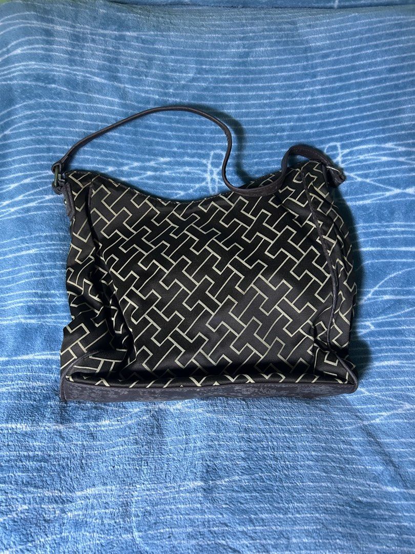 Tommy Hilfiger Monogram Shoulder Bag Dark Brown (Category: Shoulder Bags) located in Quezon City. Submitted by thriftxgoods (Listing ID 1469897100, Image 2). Description: - Brand: Tommy Hilfiger - Color/Pattern: Dark brown with iconic monogram print and dark leather trim - Storage: Main compartment with top zipper closure, inner lined pocket with brand tag, and a convenient front zippered pocket - Strap: Adjustable shoulder strap secured with dur