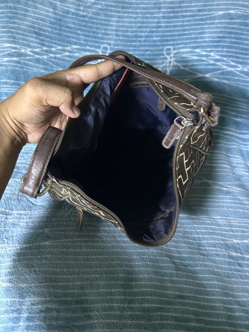 Tommy Hilfiger Monogram Shoulder Bag Dark Brown (Category: Shoulder Bags) located in Quezon City. Submitted by thriftxgoods (Listing ID 1469897100, Image 3). Description: - Brand: Tommy Hilfiger - Color/Pattern: Dark brown with iconic monogram print and dark leather trim - Storage: Main compartment with top zipper closure, inner lined pocket with brand tag, and a convenient front zippered pocket - Strap: Adjustable shoulder strap secured with dur