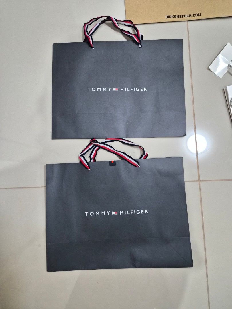 Tommy Hilfiger Paper Bag (Category: Everything Else Others) located in Paranaque City. Submitted by lovelife.312 (Listing ID 1469842383, Image 1). Description: ***PLEASE READ CAREFULLY*** - 2 pieces Medium size paper bag - decluttering room MAILING AND DELIVERY: - Meet up only SM City Sucat, Uptown Mall BGC and Ayala Malls by the Bay. - After lunch time 1pm onward. - If you prefer delivery, buyer will book courier and shoulder shipping fee. MOP: 