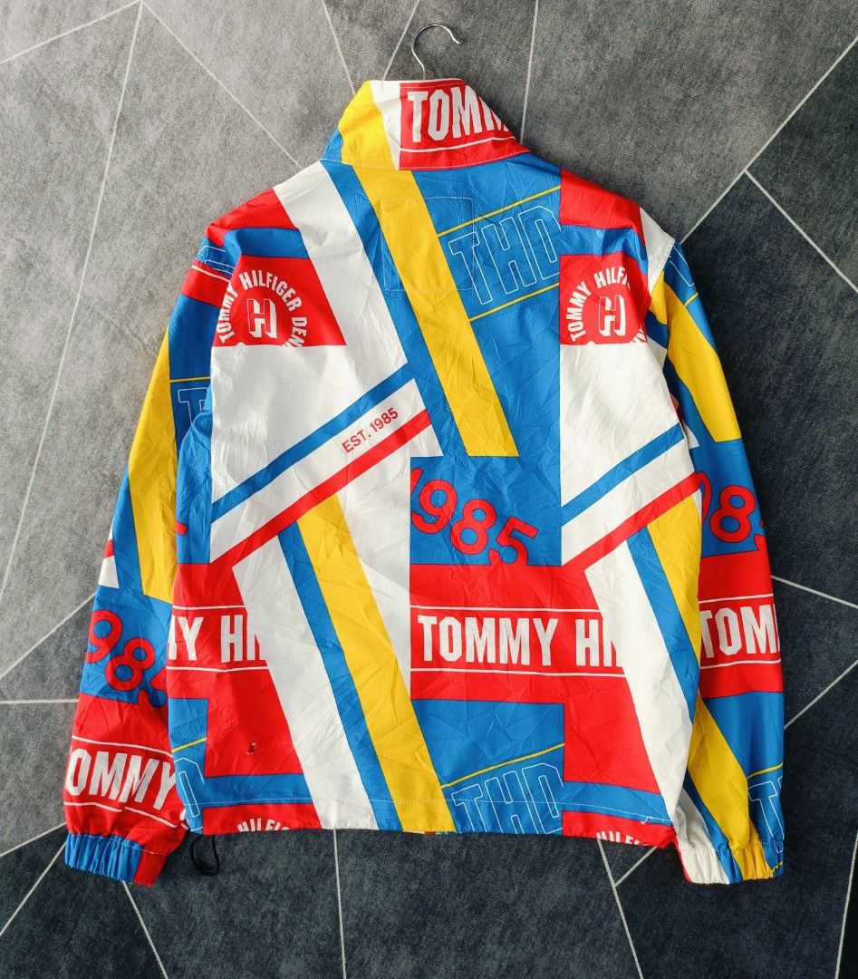 Tommy Hilfiger Retro Graphic Windbreaker (Authentic) (Category: Coats, Jackets and Outerwear) located in Cebu City. Submitted by renzecamingay (Listing ID 1469770684, Image 3). Description: Tommy Hilfiger Windbreaker Almost New Condition Large fit Width 22 Length 27 ISSUE - (Scratch on the bottom back barely noticeable) last photo 1500 Plus ship Only Thank you and GOD bless ☺️.