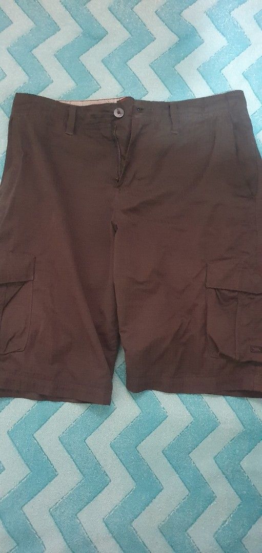 Tony Hawk Cargo Shorts Size 30 Brown (Category: Shorts) located in Manila. Submitted by koneho311 (Listing ID 1469806655, Image 1). Description: - Brand: Tony Hawk - Color: Dark Brown - Size: Waist 30 - Material: 68% polyester, 19% cotton, 13% nylon - Fabric: Durable ripstop texture - Features: Multiple side utility pockets, button and zip fly closure, branded interior waistband lining - Condition: Excellent, message for inquiries.