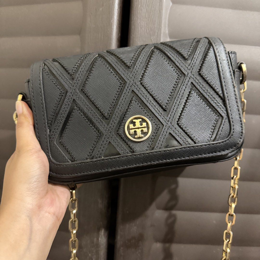 Tory Burch Black Geometric Crossbody Bag (Category: Luxury Bags & Wallets) located in Rizal. Submitted by lovegclothingph (Listing ID 1469886927, Image 1). Description: - Authentic black Tory Burch crossbody bag - Elegant geometric diamond pattern flap with signature gold logo medallion - Durable and sturdy saffiano leather texture in a structured rectangular silhouette - Luxurious gold chain strap with links on both sides - Features a secure mai