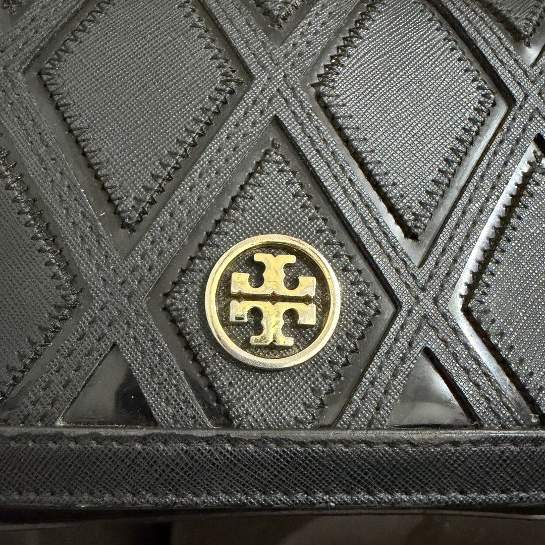Tory Burch Black Geometric Crossbody Bag (Category: Luxury Bags & Wallets) located in Rizal. Submitted by lovegclothingph (Listing ID 1469886927, Image 2). Description: - Authentic black Tory Burch crossbody bag - Elegant geometric diamond pattern flap with signature gold logo medallion - Durable and sturdy saffiano leather texture in a structured rectangular silhouette - Luxurious gold chain strap with links on both sides - Features a secure mai
