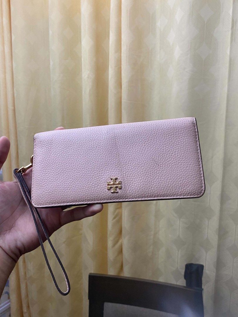 Tory Burch Pink Leather Wristlet Wallet (Category: Luxury Bags & Wallets) located in Cagayan de Oro. Submitted by caga67813 (Listing ID 1469914607, Image 1). Description: - Brand: Tory Burch - Material: Pale pink pebble leather - Hardware: Gold-tone with classic front logo stamp - Closure: Snap button - Interior: Multiple card slots and a secure zippered compartment - Extras: Attached side wrist strap - Condition: Clean inside and out, perfect fo
