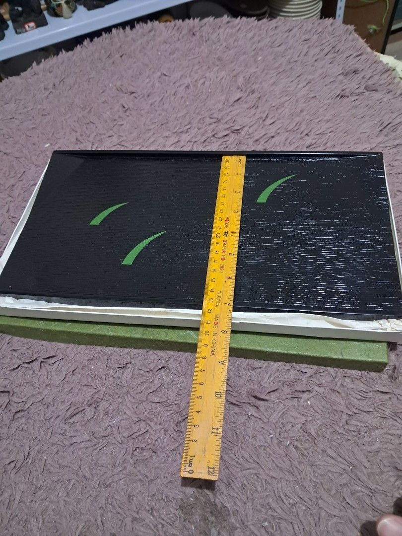Tray (Category: Dinnerware & Cutlery) located in Cavite. Submitted by secretjapansurplus (Listing ID 1469903919, Image 3). Description: This elegant Japanese lacquerware (Kyo-shikki) serving tray features a textured black finish mimicking natural wood grain, accented with minimalistic vivid green lacquer strokes representing spring buds. It is traditionally used to serve a single tea cup alongside seasonal sweets to house guests..