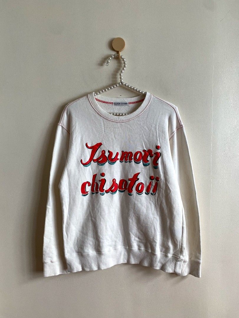 Tsumori Chisato Logo Print Sweatshirt (Category: Others Tops) located in Castillejos. Submitted by lalainecloset22 (Listing ID 1469793778, Image 3). Description: - Brand: Tsumori Chisato (Issey Miyake) - Item: Logo Print Sweatshirt - Size: M (EU 38 / UK 10 / US 6) - Color: Off-white with red and blue graphic lettering - Condition: 4/4 (Very good, well-maintained) - Features: Contrast red stitching details, soft crewneck style, great for layering 