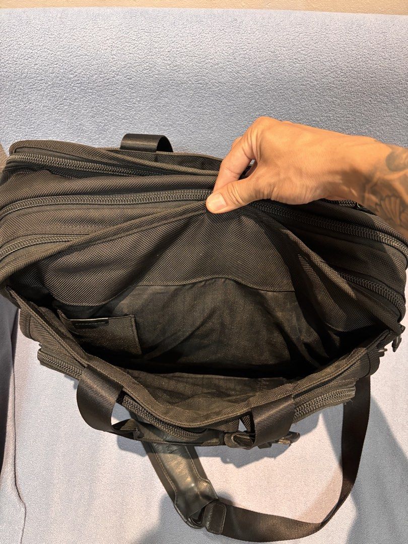 Tumi Alpha 26197DH Expandable Briefcase Laptop Bag (Category: Briefcases) located in Mabalacat. Submitted by _limitlessfashion (Listing ID 1469760432, Image 3). Description: -authentic tumi alpha expandable broefcase - No major issue - Color rate & condition 9.5/10 - Color may vary due to lighting Tumi Alpha 26197DH black ballistic nylon briefcase. Multiple zip compartments on the front. Double top handles and adjustable shoulder strap with leath