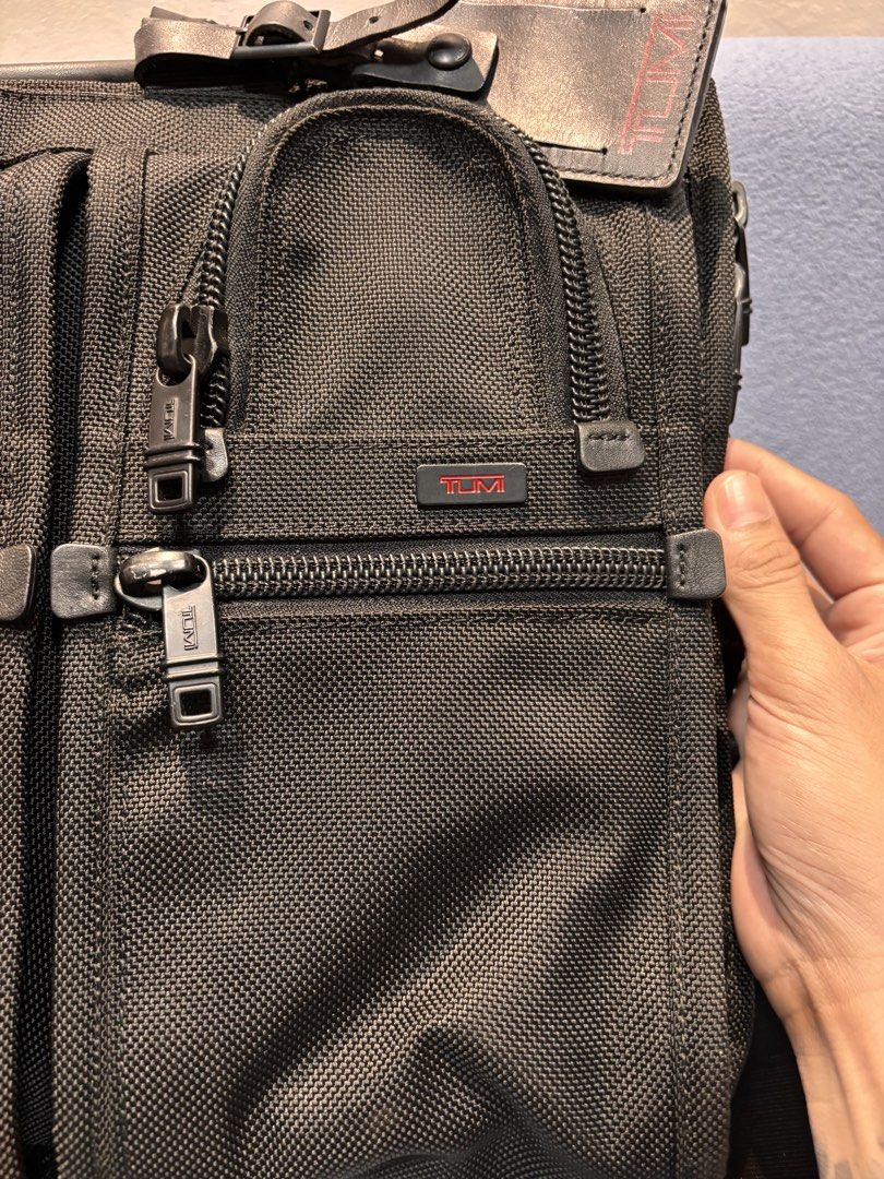 Tumi Alpha 26197DH Expandable Briefcase Laptop Bag (Category: Briefcases) located in Mabalacat. Submitted by _limitlessfashion (Listing ID 1469760432, Image 2). Description: -authentic tumi alpha expandable broefcase - No major issue - Color rate & condition 9.5/10 - Color may vary due to lighting Tumi Alpha 26197DH black ballistic nylon briefcase. Multiple zip compartments on the front. Double top handles and adjustable shoulder strap with leath