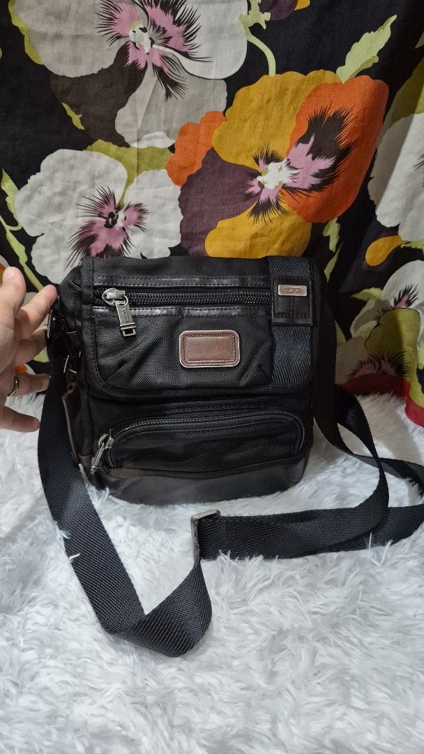 TUMI Black and Brown Crossbody Bag (Category: Cross-body Bags) located in Baguio. Submitted by jhaz_bags (Listing ID 1469900768, Image 1). Description: - Brand: TUMI - Color: Black and brown - Material: Durable ballistic nylon with leather trim - Compartments: Multiple zippered compartments for easy organization - Strap: Adjustable black shoulder strap included - Condition: Clean interior and exterior, ready to use - Best for: Daily commute, trav