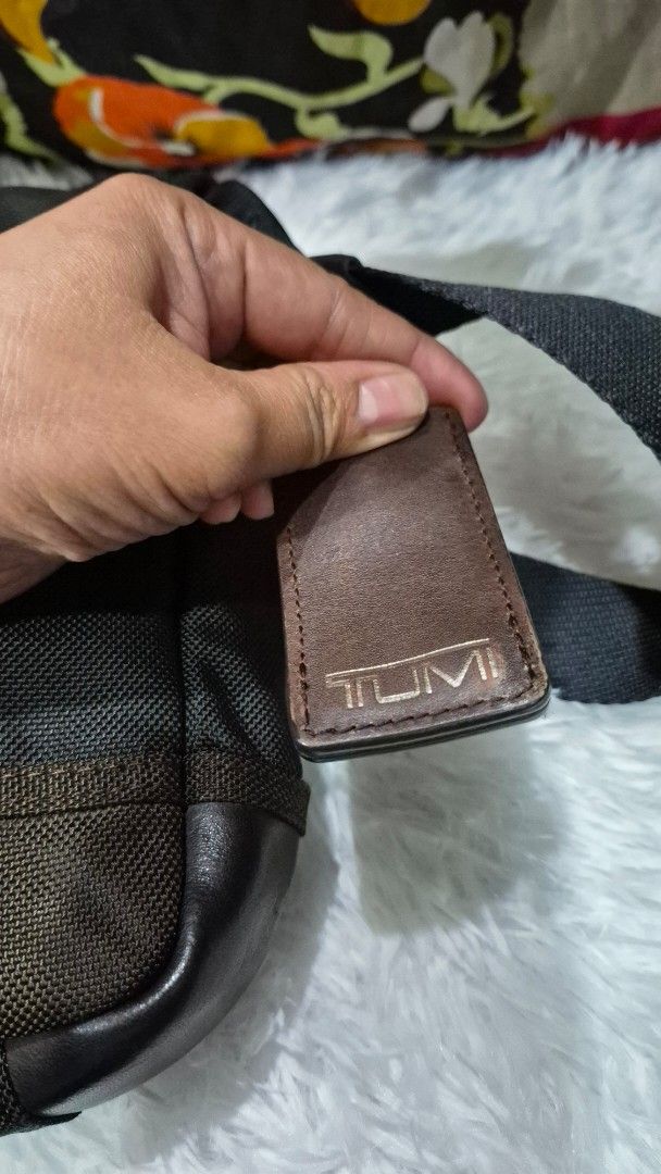 TUMI Black and Brown Crossbody Bag (Category: Cross-body Bags) located in Baguio. Submitted by jhaz_bags (Listing ID 1469900768, Image 2). Description: - Brand: TUMI - Color: Black and brown - Material: Durable ballistic nylon with leather trim - Compartments: Multiple zippered compartments for easy organization - Strap: Adjustable black shoulder strap included - Condition: Clean interior and exterior, ready to use - Best for: Daily commute, trav