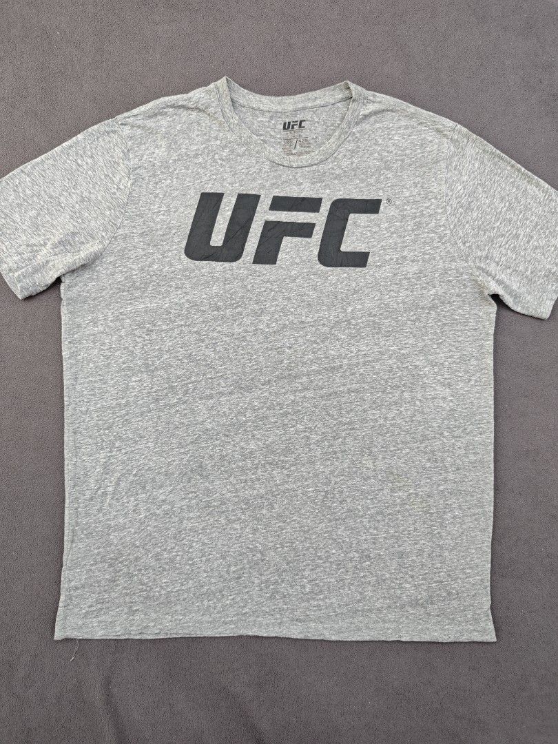 UFC Grey T-Shirt Size XL (Category: Tshirts & Polo Shirts ) located in Bulacan. Submitted by pzj_thrift (Listing ID 1469797691, Image 1). Description: condition 9/10 color rate 9/10 no issue.
