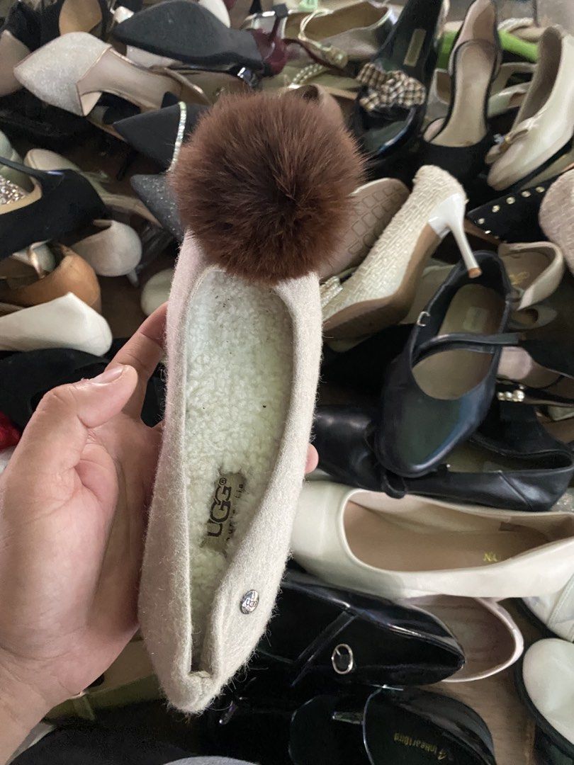 UGG Slippers with Pom Pom Cream Color (Category: Slippers and slides) located in Alburquerque. Submitted by zanegavynn43872 (Listing ID 1469944505, Image 3). Description: - Brand: UGG - Color: Cream with white fleece lining - Feature: Large brown fur pom pom on the front toe - Material: Soft felt upper - Sole: Flat with all-over UGG logo pattern, minimal wear - Style: Easy slip-on for casual indoor/outdoor use.
